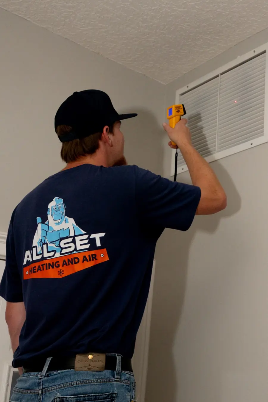 An All Set technician checking an air return