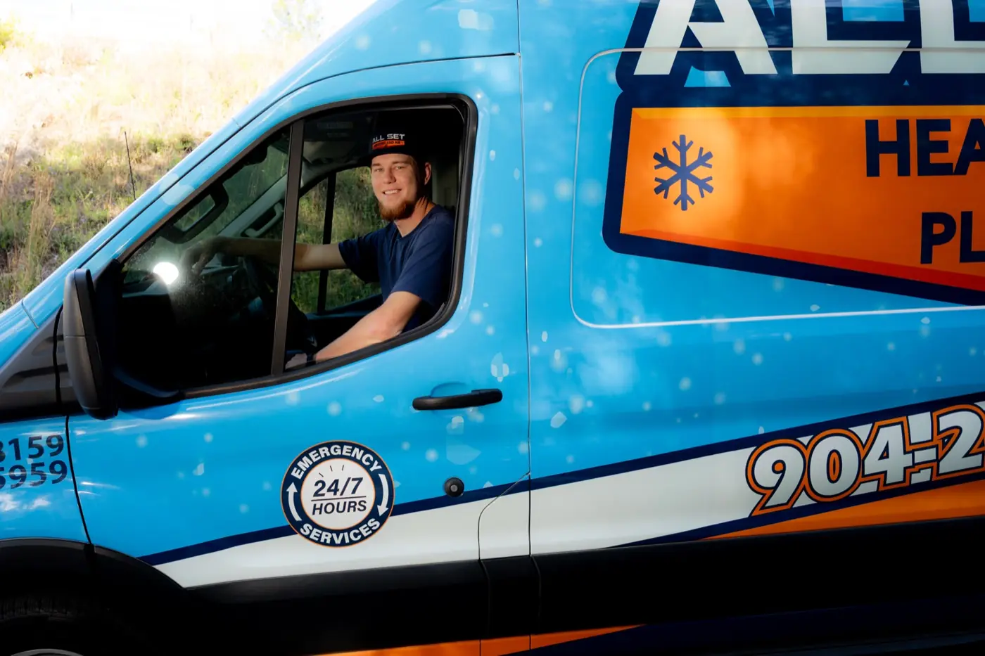 An All Set technician driving a service van